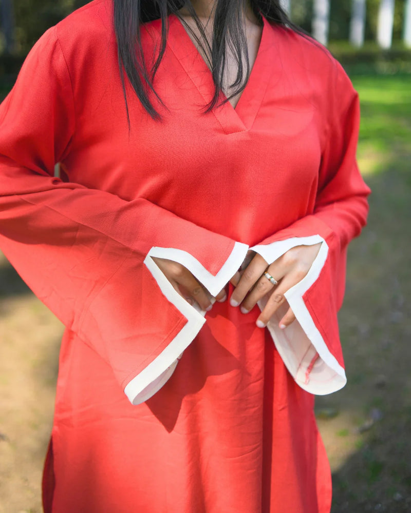 Person wearing a red outfit with white trim in an outdoor setting