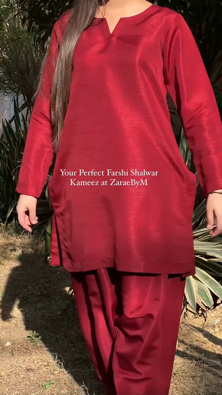 Red traditional outfit with text overlay on a natural background